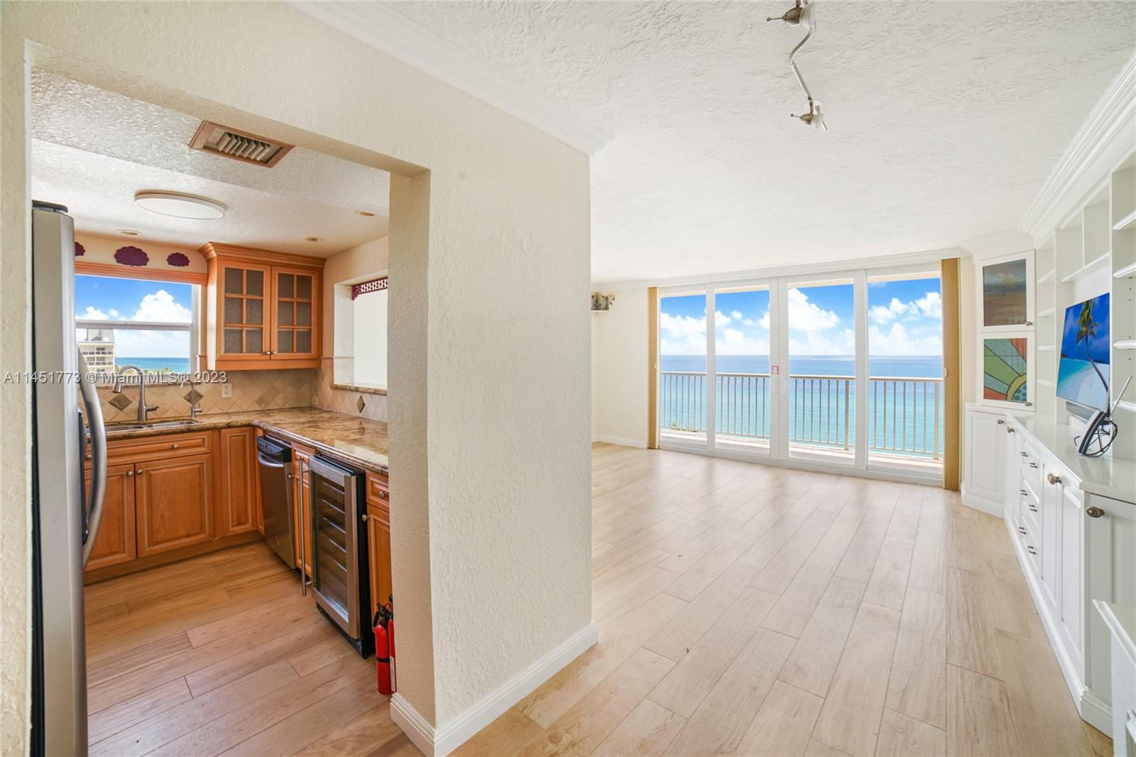 400 North Surf Road, Unit 801 Hollywood, FL 33019 - Photo 4 of 17 a view of a kitchen with a sink stove top oven and cabinets