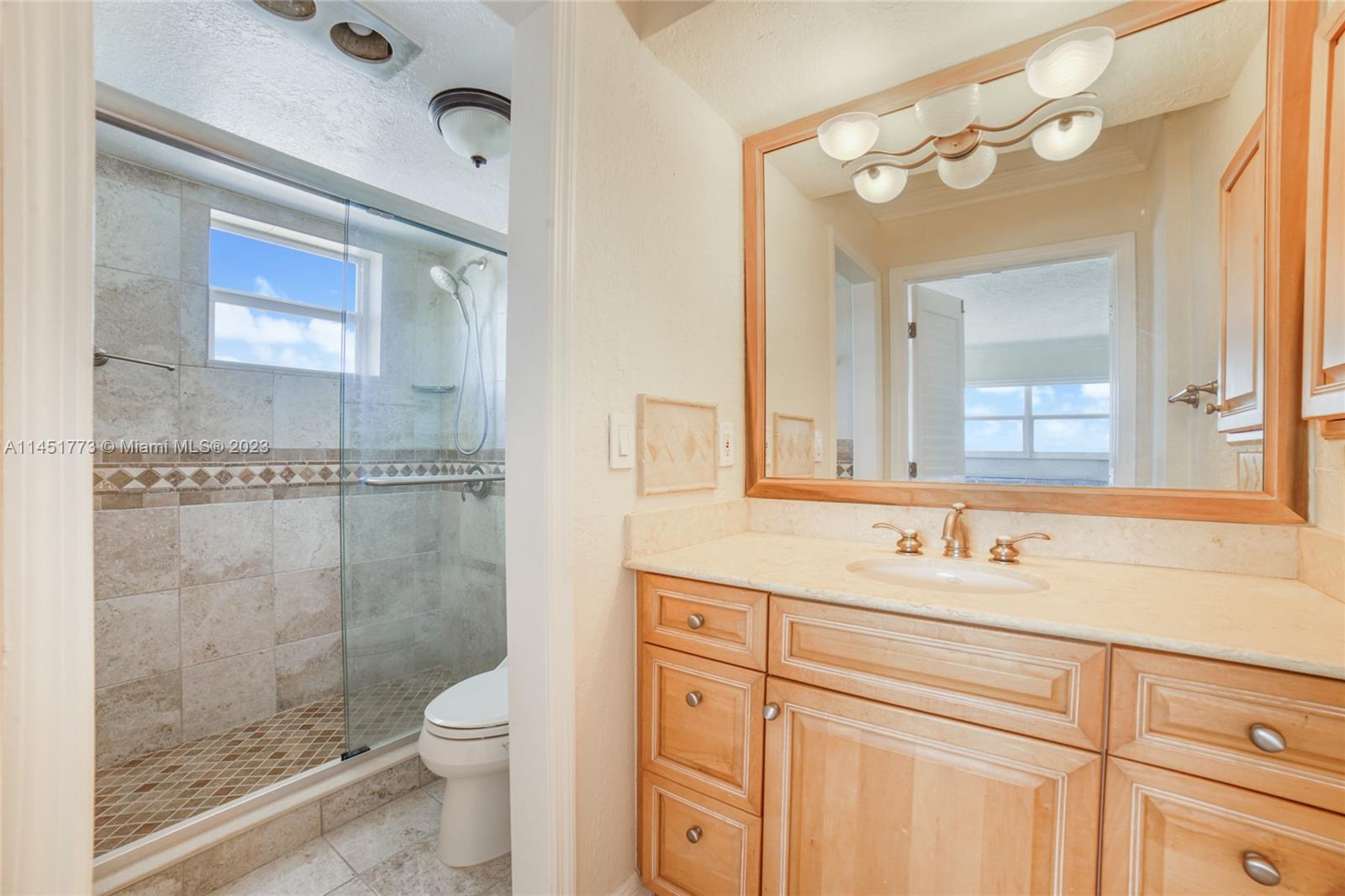 400 North Surf Road, Unit 801 Hollywood, FL 33019 - Photo 9 of 17 a bathroom with a sink a toilet and shower