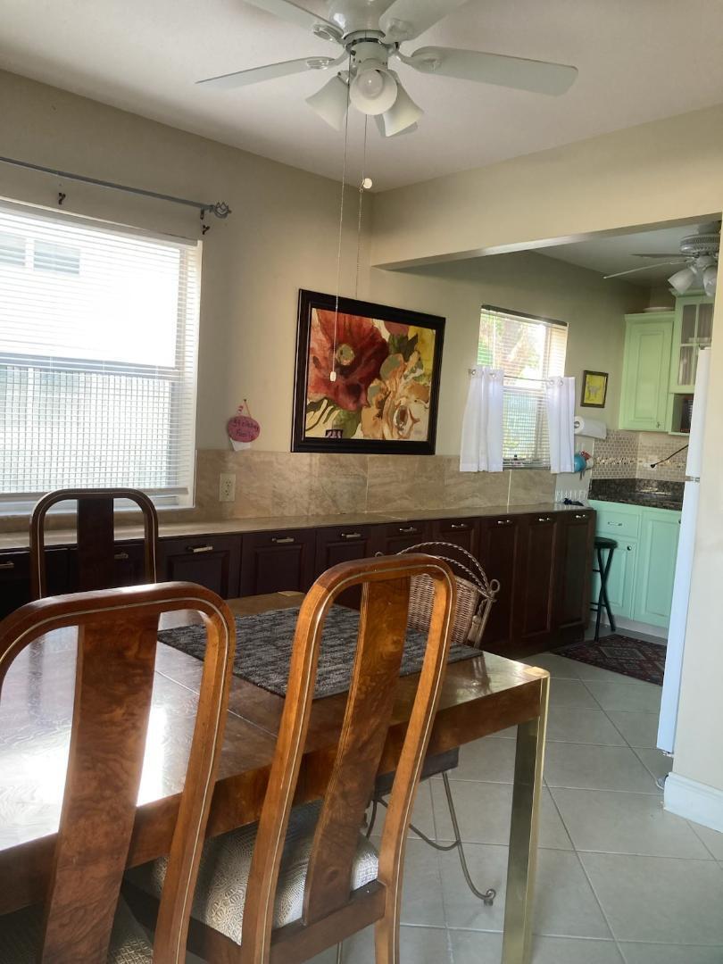 445 Saxony Way, Unit 445 Delray Beach, FL 33446 - Photo 4 of 10 a view of a dining room with furniture and window