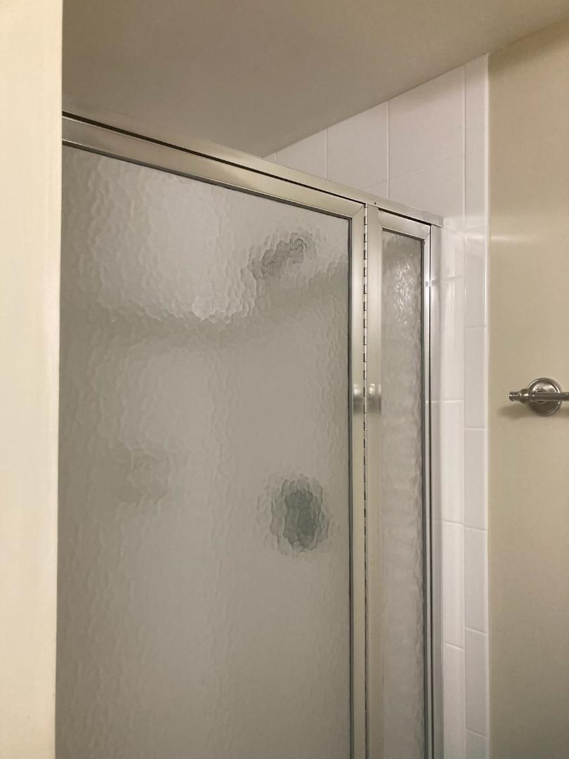 445 Saxony Way, Unit 445 Delray Beach, FL 33446 - Photo 9 of 10 a bathroom with a glass shower door