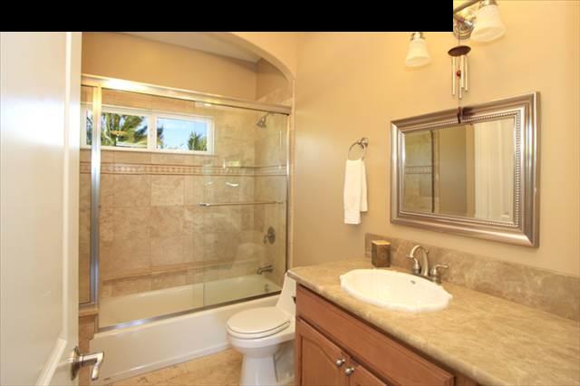 220 North Holokai Road Haiku, HI 96708 - Photo 18 of 29 a bathroom with a granite countertop sink toilet and shower