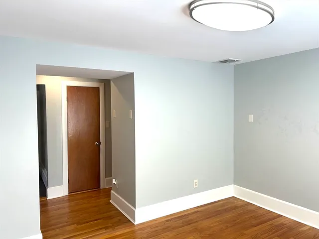 a view of a room with wooden floor and bathroom