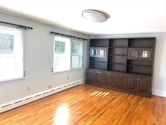 a room with a window and wooden floor