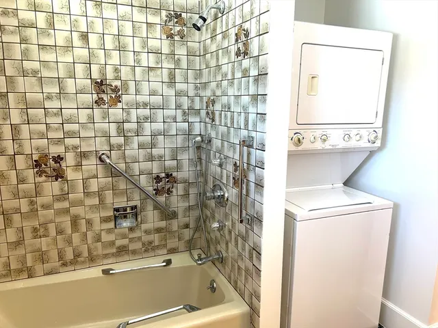 a bathroom with a bathtub and a shower