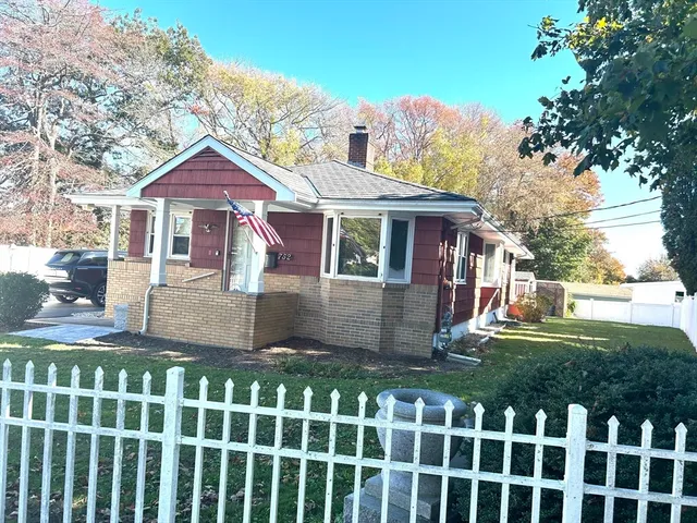 a front view of house with yard and green space