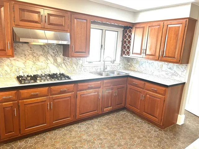 a kitchen with granite countertop cabinets sink and window