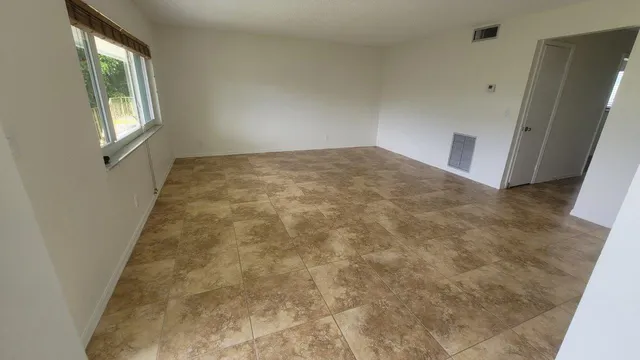 a view of an empty room with windows