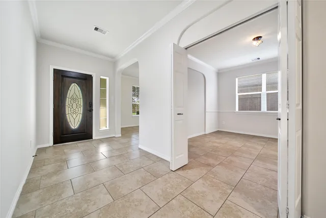 an empty room with entrance and windows