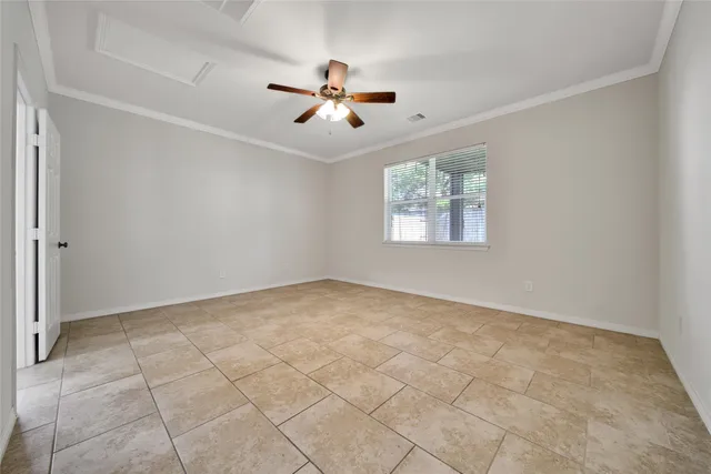 an empty room with windows and fan