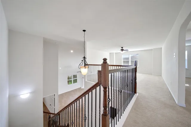 a view of a hallway to a livingroom with furniture and staircase