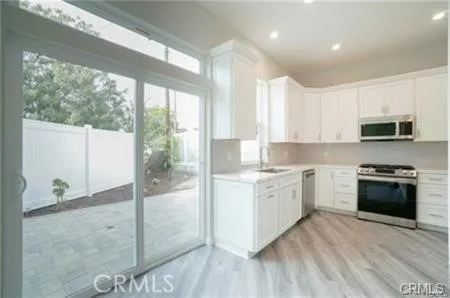 a kitchen with a stove a sink and a refrigerator