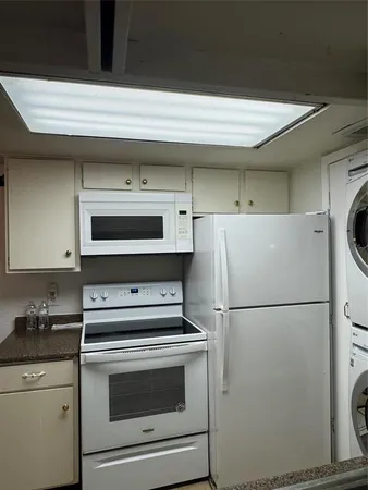 a kitchen with a refrigerator and a stove top oven