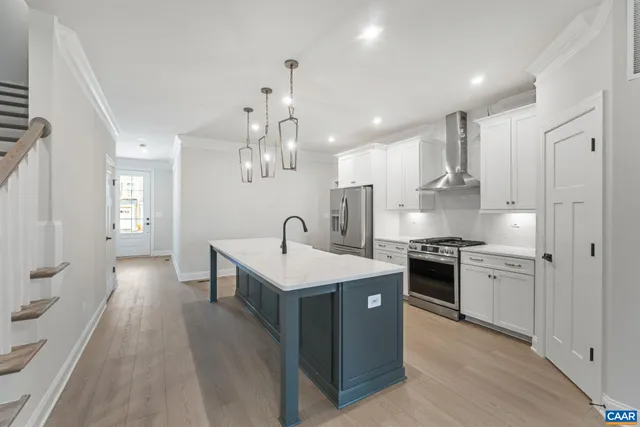 a view of an empty room with a fireplace and a window