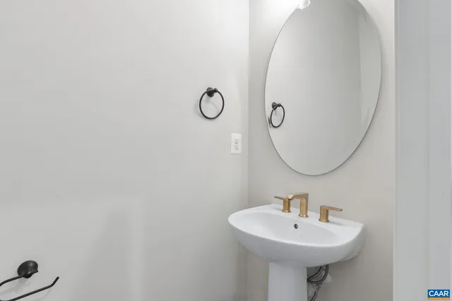 a large kitchen with stainless steel appliances kitchen island a stove a refrigerator a sink dishwasher a oven and a fireplace with wooden floor