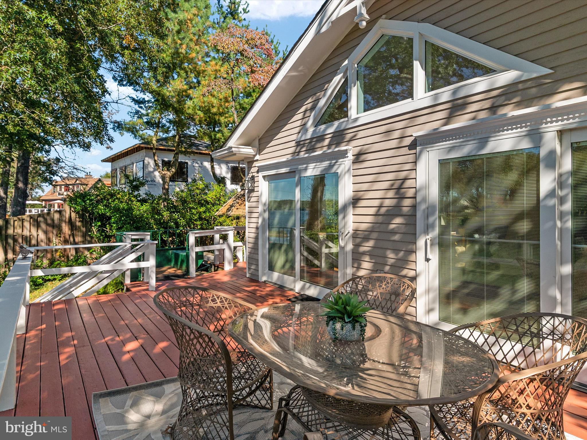 111 Virginia Avenue Edgewater, MD 21037 - Photo 44 of 80 a view of a patio with table and chairs potted plants with wooden floor and fence