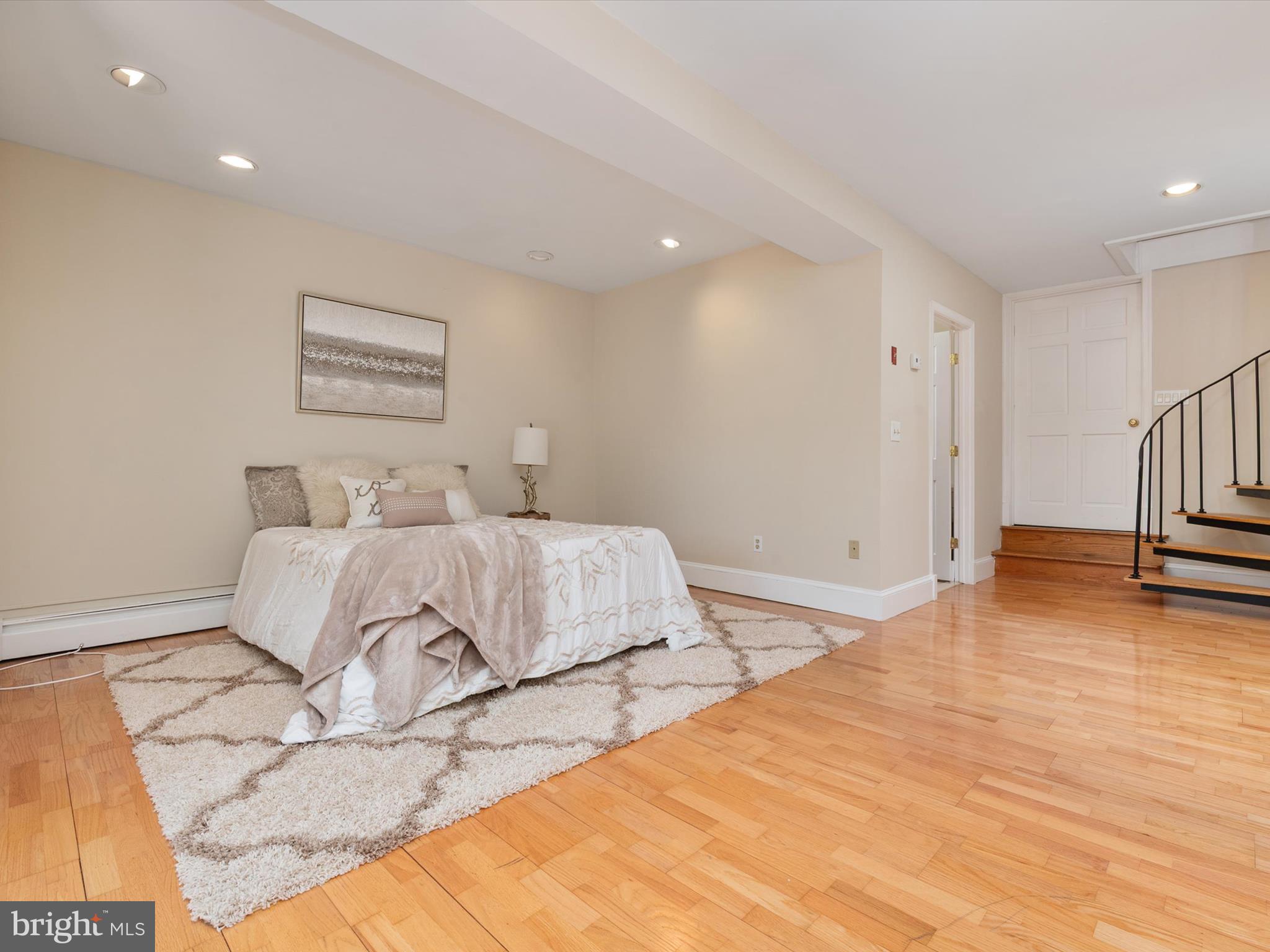 111 Virginia Avenue Edgewater, MD 21037 - Photo 61 of 80 a bedroom with a bed and a wooden floor