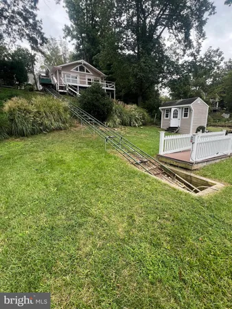 a view of a house with a yard and pathway