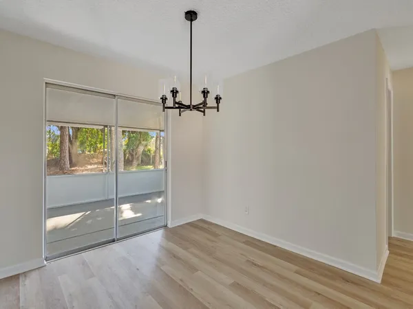 a view of an empty room with glass door