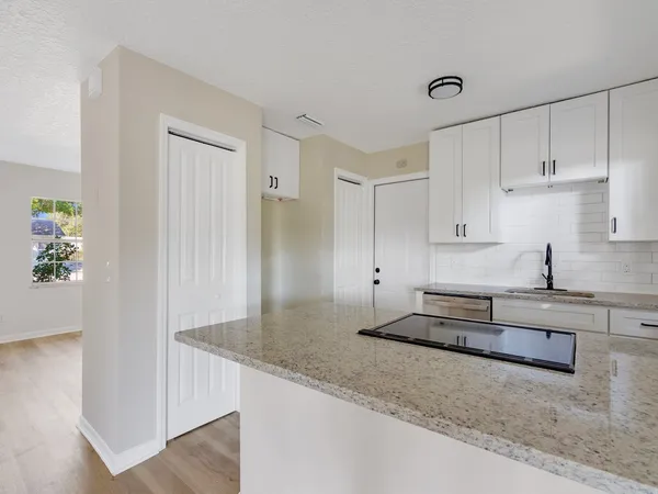 a kitchen with granite countertop white cabinets and a granite counter tops