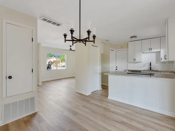 a view of a kitchen with a sink and dishwasher wooden floor