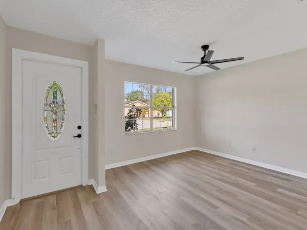 wooden floor in an empty room with a window