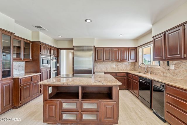 a kitchen with a stove a sink and a refrigerator