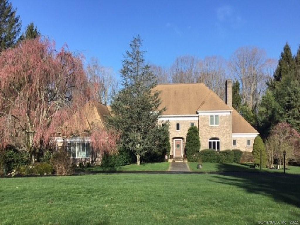 6 October Hill Road Woodbridge, CT 06525 - Photo 1 of 1 a view of a white house with a big yard and large trees