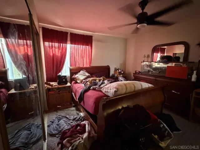 a bedroom with a bed and a mirror