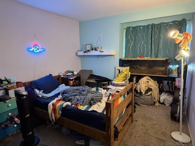 a bedroom with bed and a window