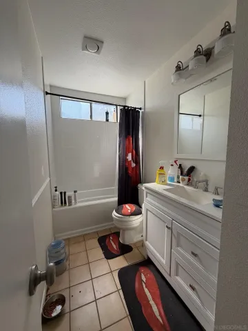 a bathroom with a sink mirror vanity and toilet