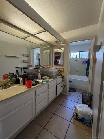 a room with sink cabinets and flat screen tv