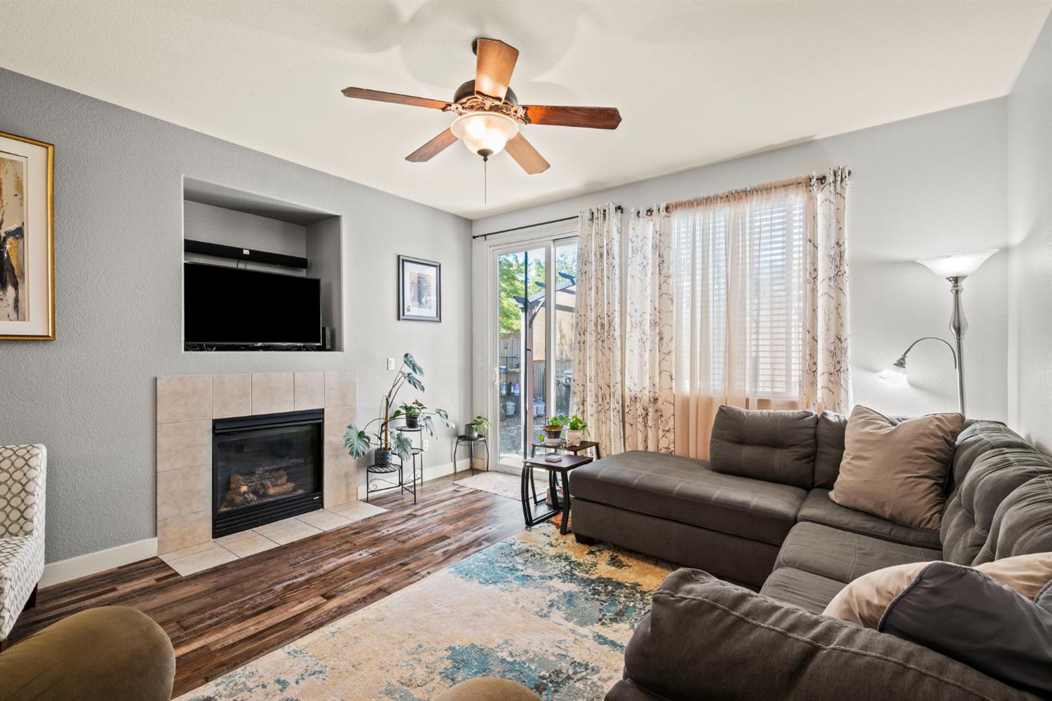 4403 Niobe Circle Rancho Cordova, CA 95742 - Photo 14 of 29 a living room with furniture a fireplace and a flat screen tv