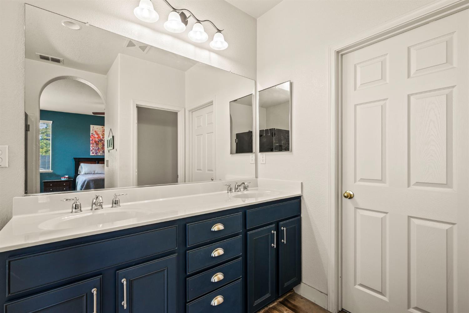 4403 Niobe Circle Rancho Cordova, CA 95742 - Photo 19 of 29 a bathroom with a double vanity sink and a mirror