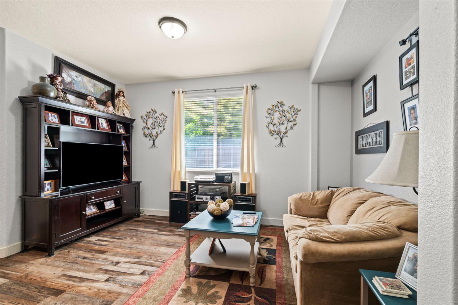 4403 Niobe Circle Rancho Cordova, CA 95742 - Photo 8 of 29 a living room with furniture and a flat screen tv