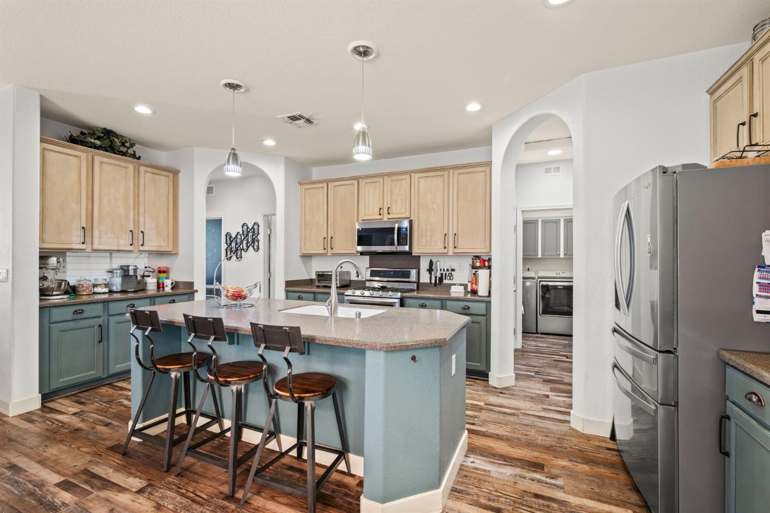4403 Niobe Circle Rancho Cordova, CA 95742 - Photo 9 of 29 a kitchen with stainless steel appliances kitchen island granite countertop a refrigerator and a stove top oven