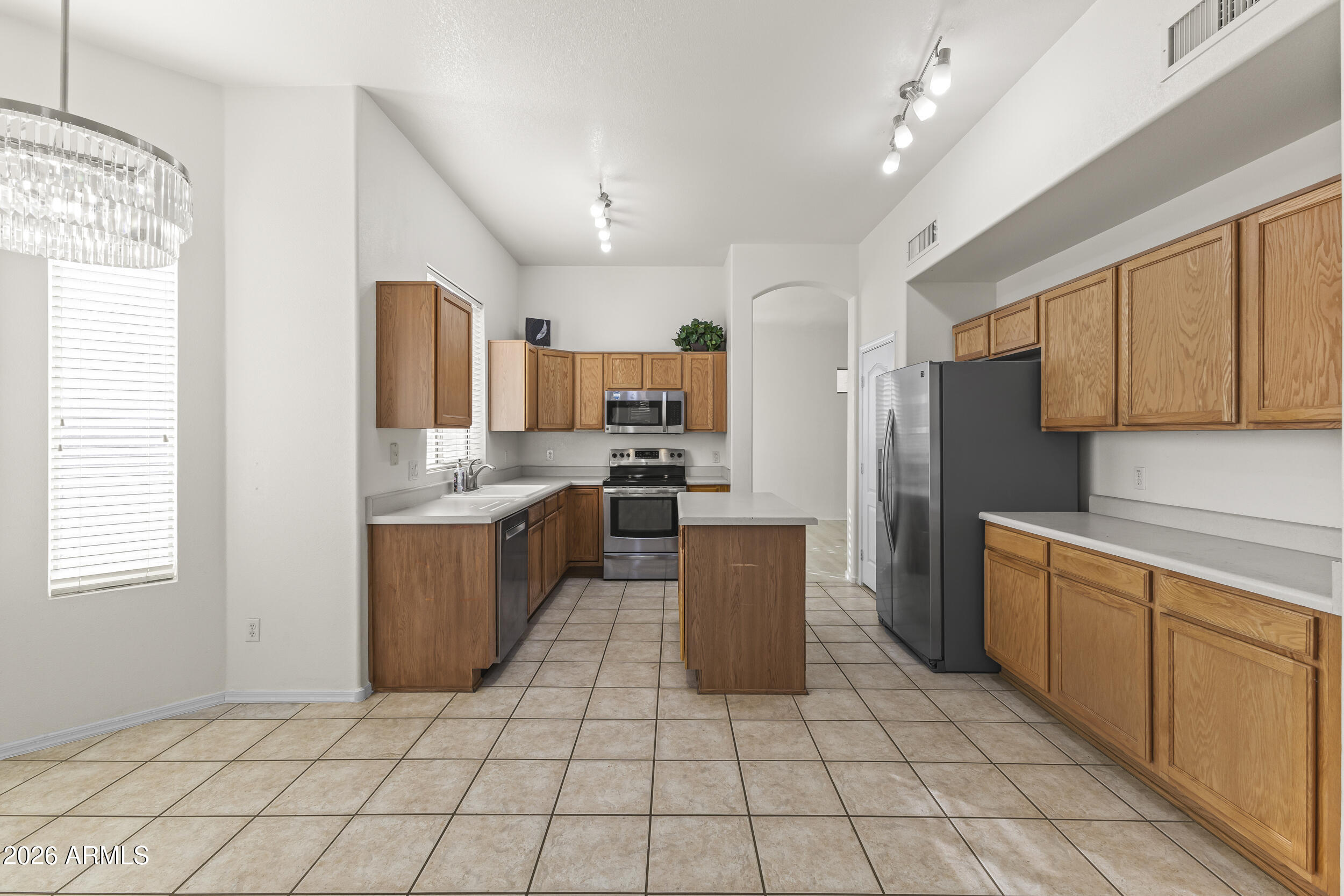 17639 North 17th Street Phoenix, AZ 85022 - Photo 12 of 42 a kitchen with stainless steel appliances a refrigerator sink and microwave
