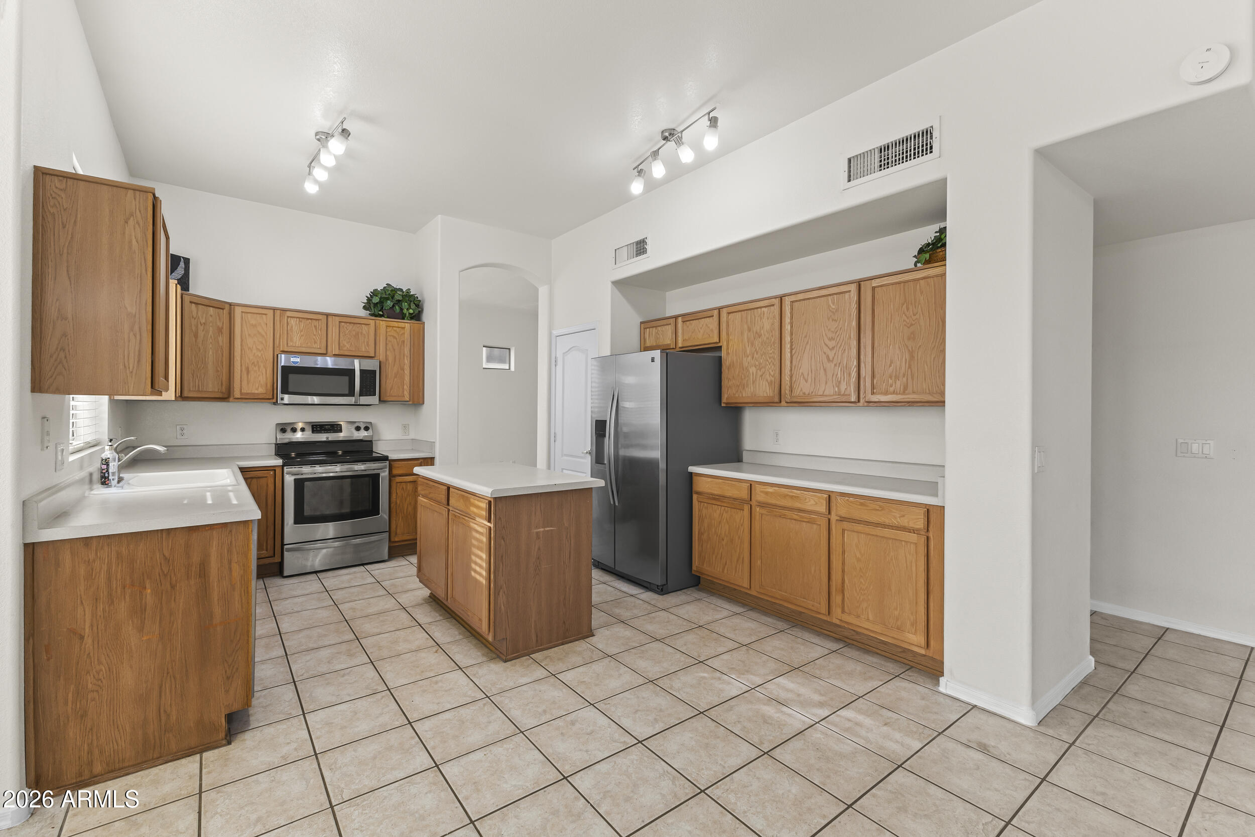 17639 North 17th Street Phoenix, AZ 85022 - Photo 13 of 42 a kitchen with stainless steel appliances granite countertop a stove top oven a sink a counter top space and cabinets