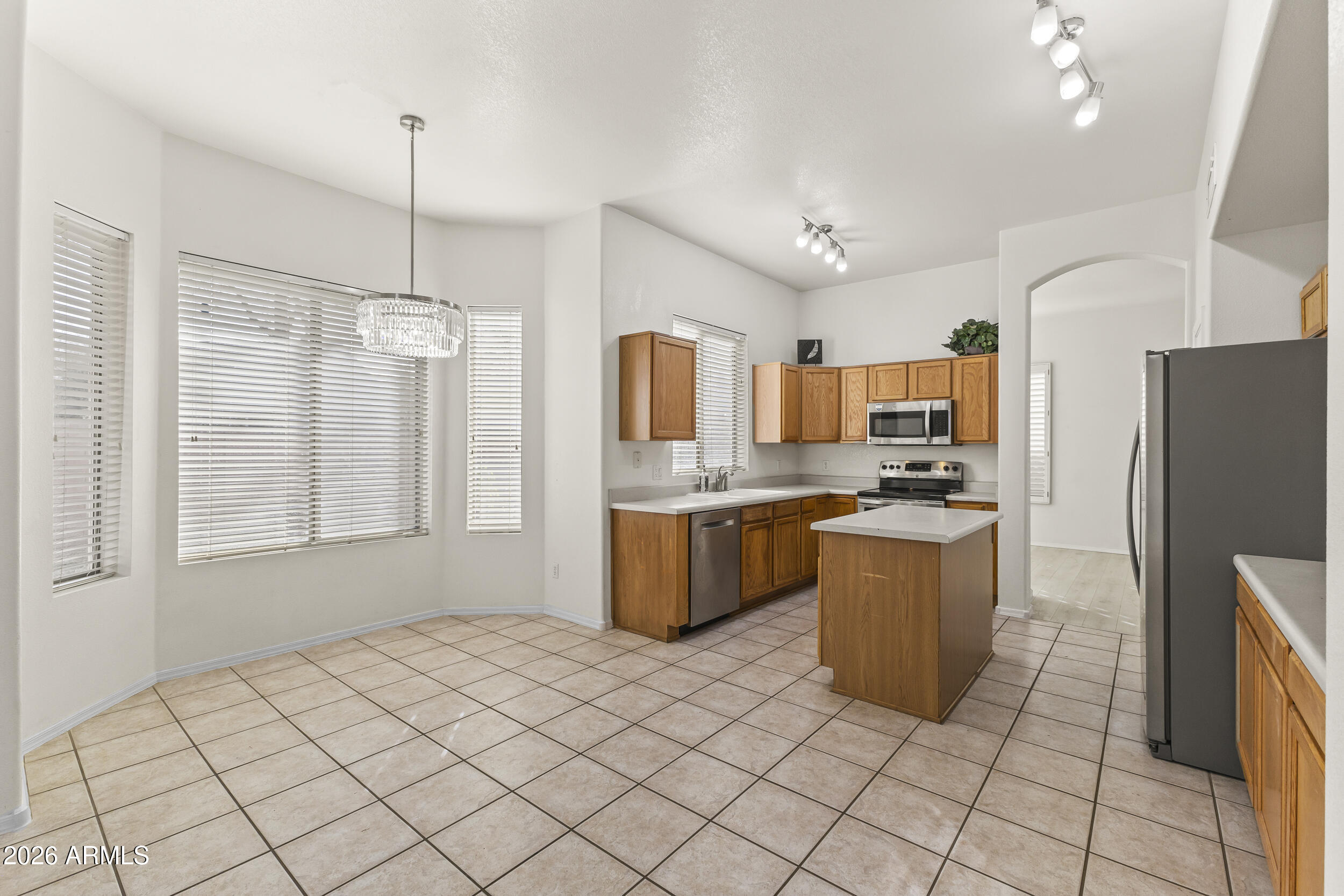 17639 North 17th Street Phoenix, AZ 85022 - Photo 14 of 42 a kitchen with granite countertop a refrigerator a sink a stove top oven and cabinets