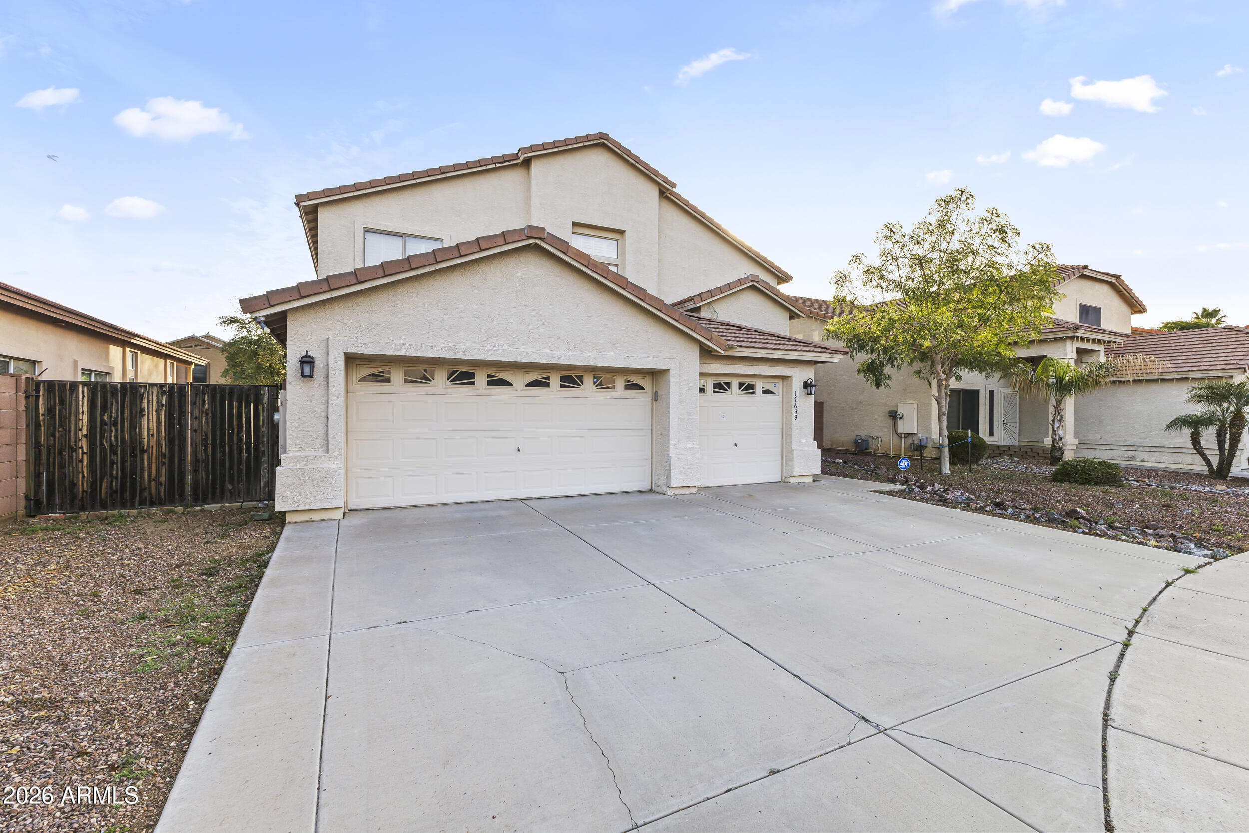 17639 North 17th Street Phoenix, AZ 85022 - Photo 2 of 42 a front view of a house with a yard and garage