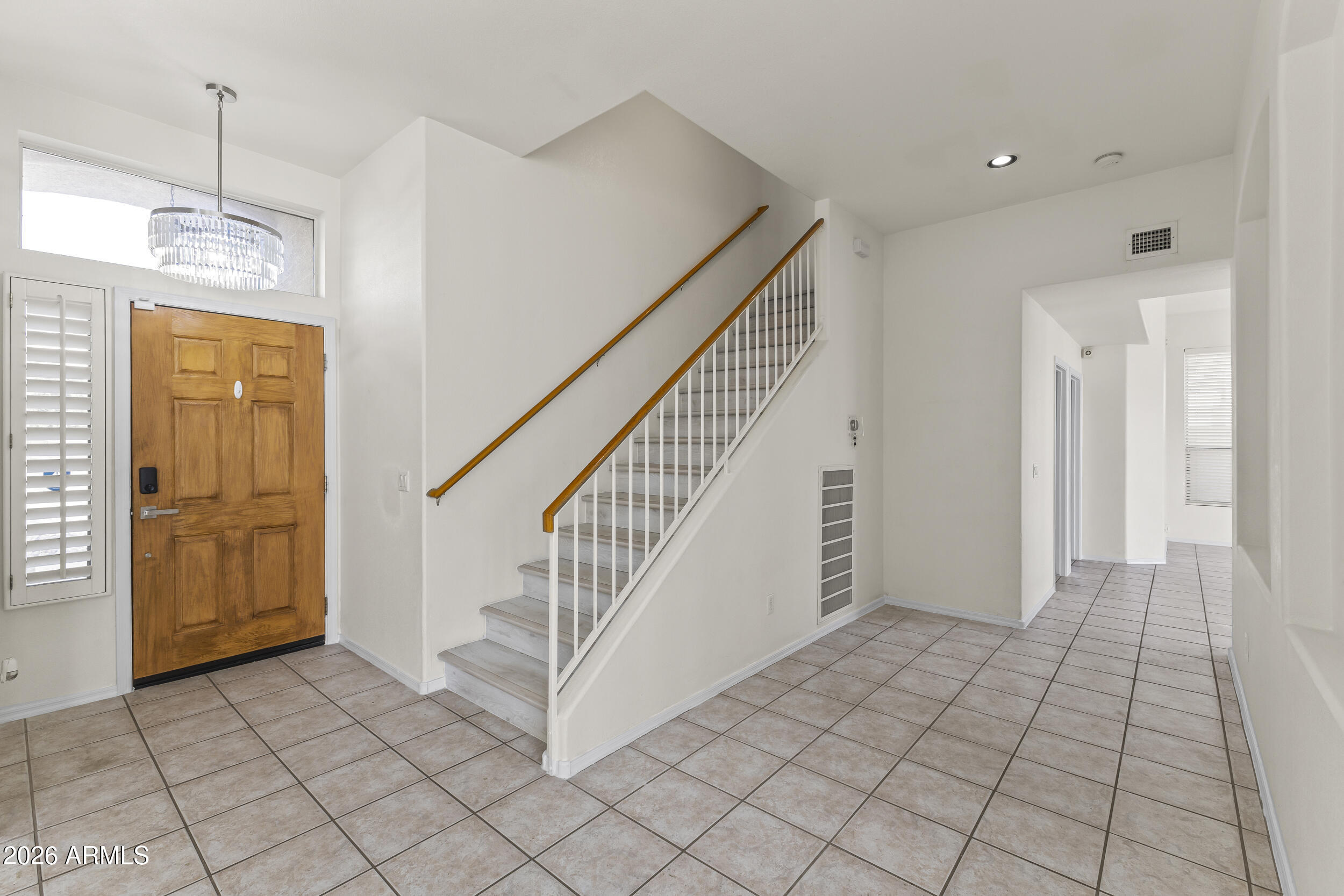 17639 North 17th Street Phoenix, AZ 85022 - Photo 4 of 42 a view of hallway with stairs and a chandelier