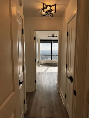 a view of a hallway with wooden floor