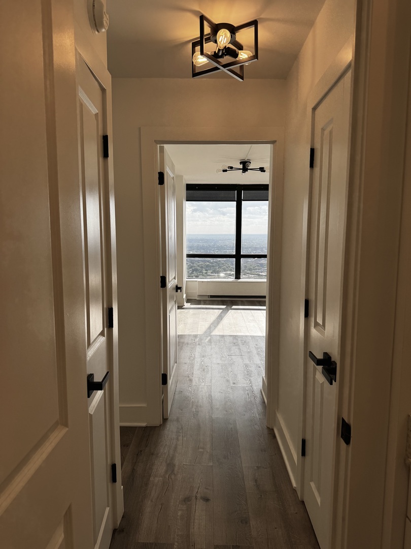 5415 North Sheridan Road, Unit 5414 Chicago, IL 60640 - Photo 12 of 18 a view of a hallway with wooden floor