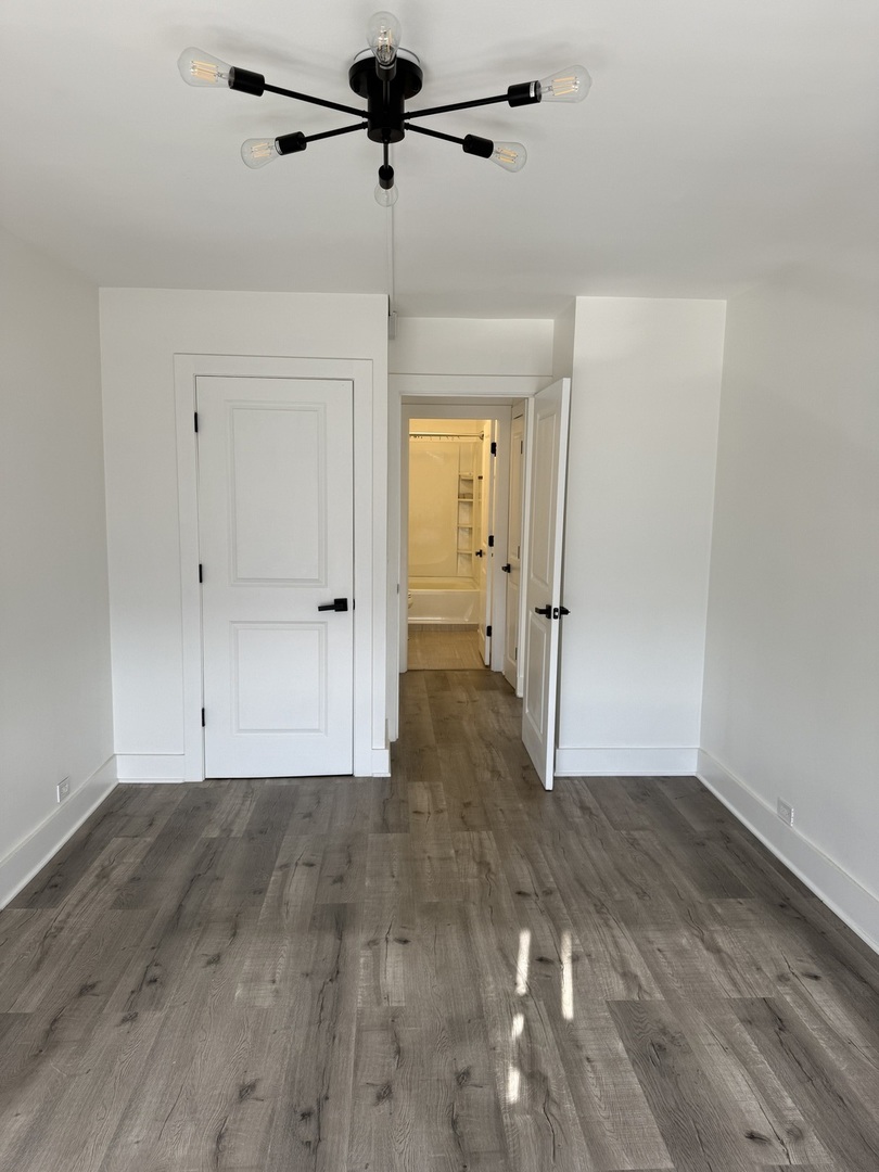 5415 North Sheridan Road, Unit 5414 Chicago, IL 60640 - Photo 15 of 18 a view of empty room with wooden floor