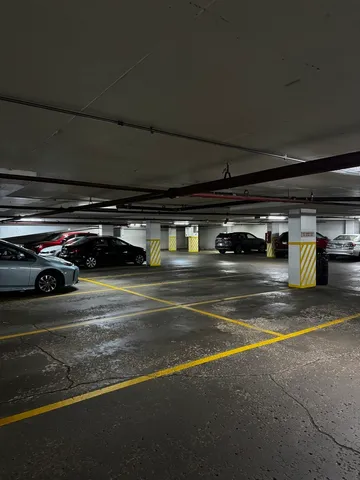 a view of parking garage with cars