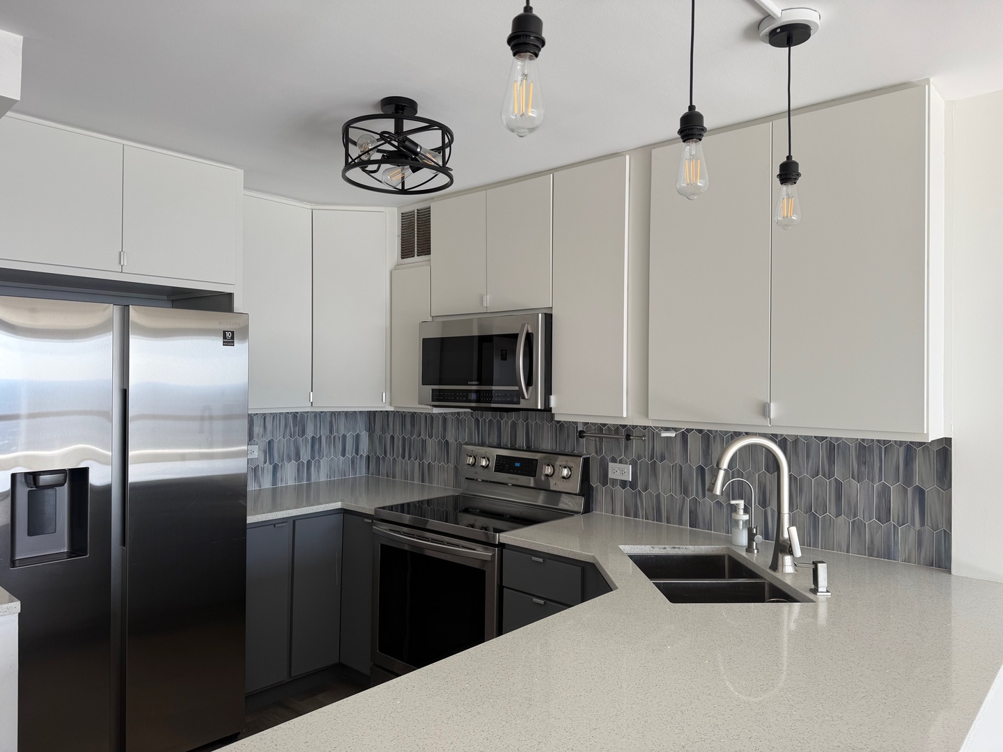 5415 North Sheridan Road, Unit 5414 Chicago, IL 60640 - Photo 4 of 18 a kitchen with stainless steel appliances granite countertop a sink a stove and a refrigerator