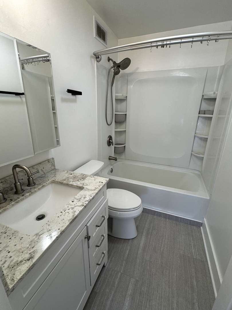 5415 North Sheridan Road, Unit 5414 Chicago, IL 60640 - Photo 10 of 18 a bathroom with a granite countertop sink toilet and shower