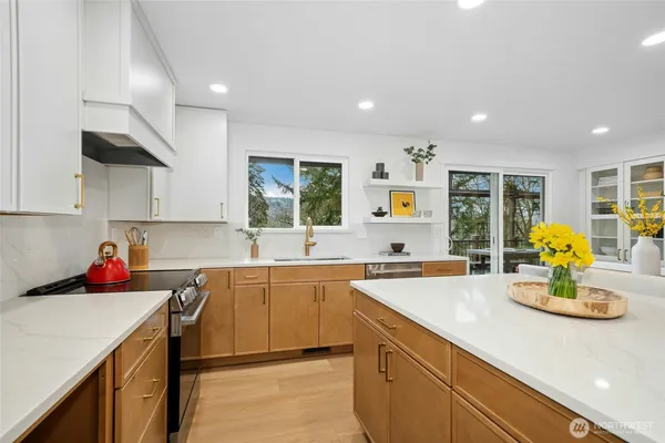 a kitchen with a sink a stove cabinets counter space and living room