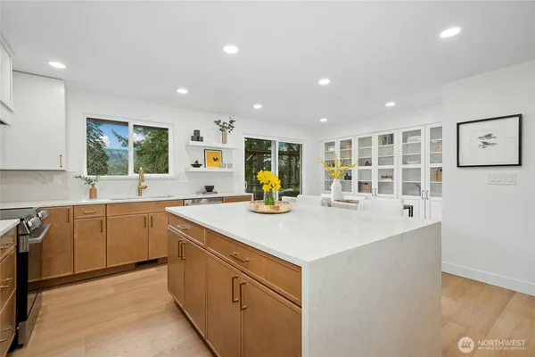a kitchen with a sink and large window