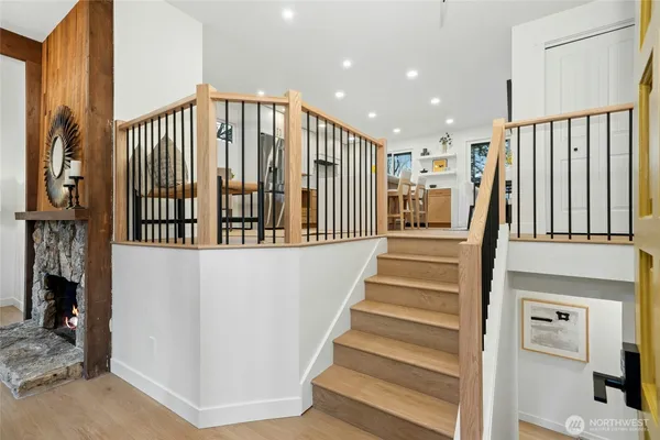 a view of entryway and hall with wooden floor