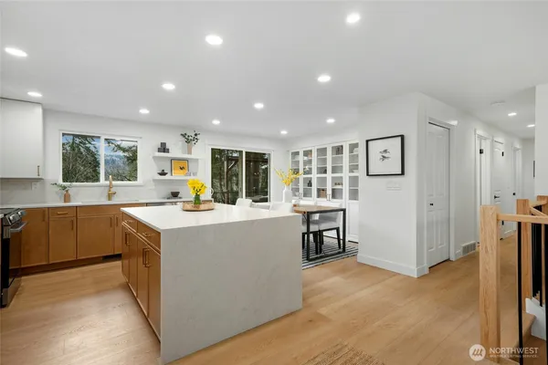 a kitchen with kitchen island sink stove and refrigerator